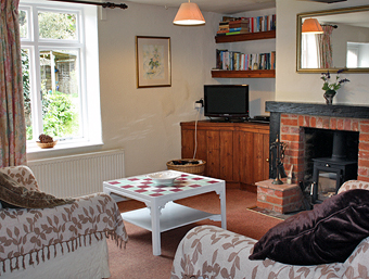 Rose Cottage cosy living room with wood burner stove